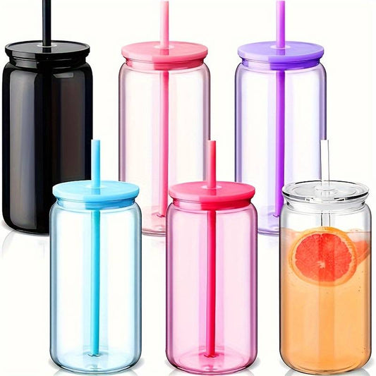 Set of colorful jars with lids and straws on a white background